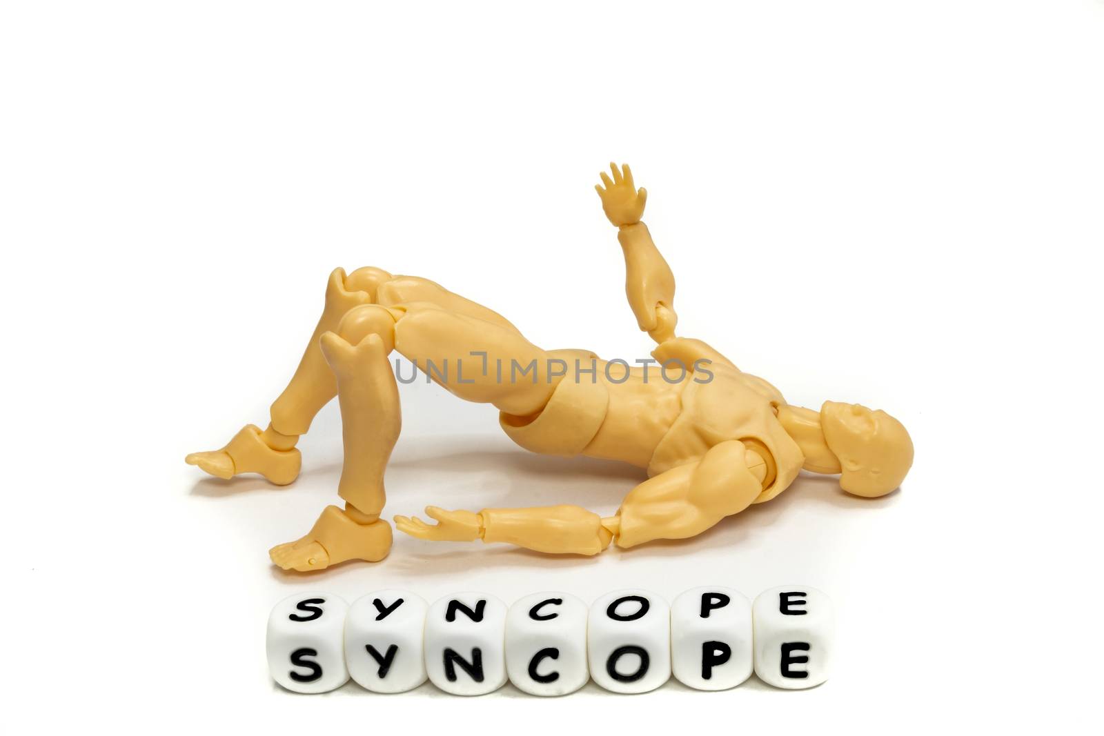 A plastic model and alphabet letters spelling syncope. Medical emergency concept. Isolated on white background.