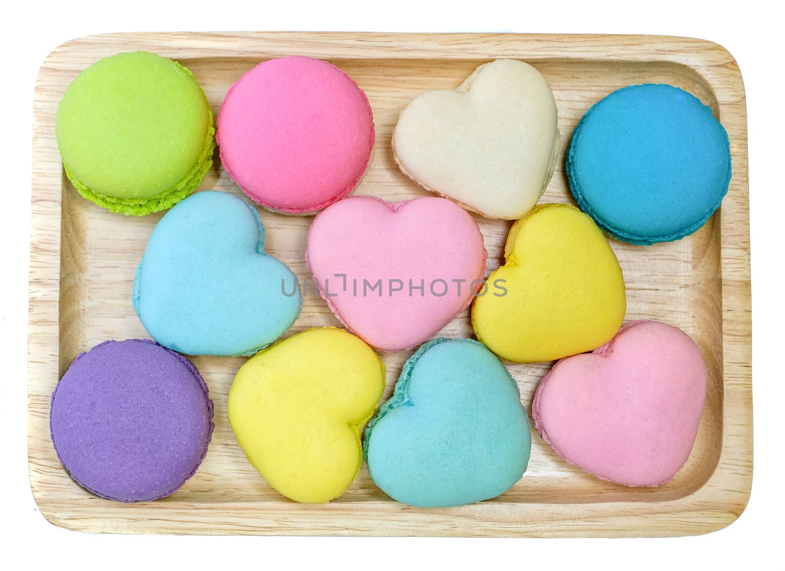 multi colored macaroons on a wooden trey, top view