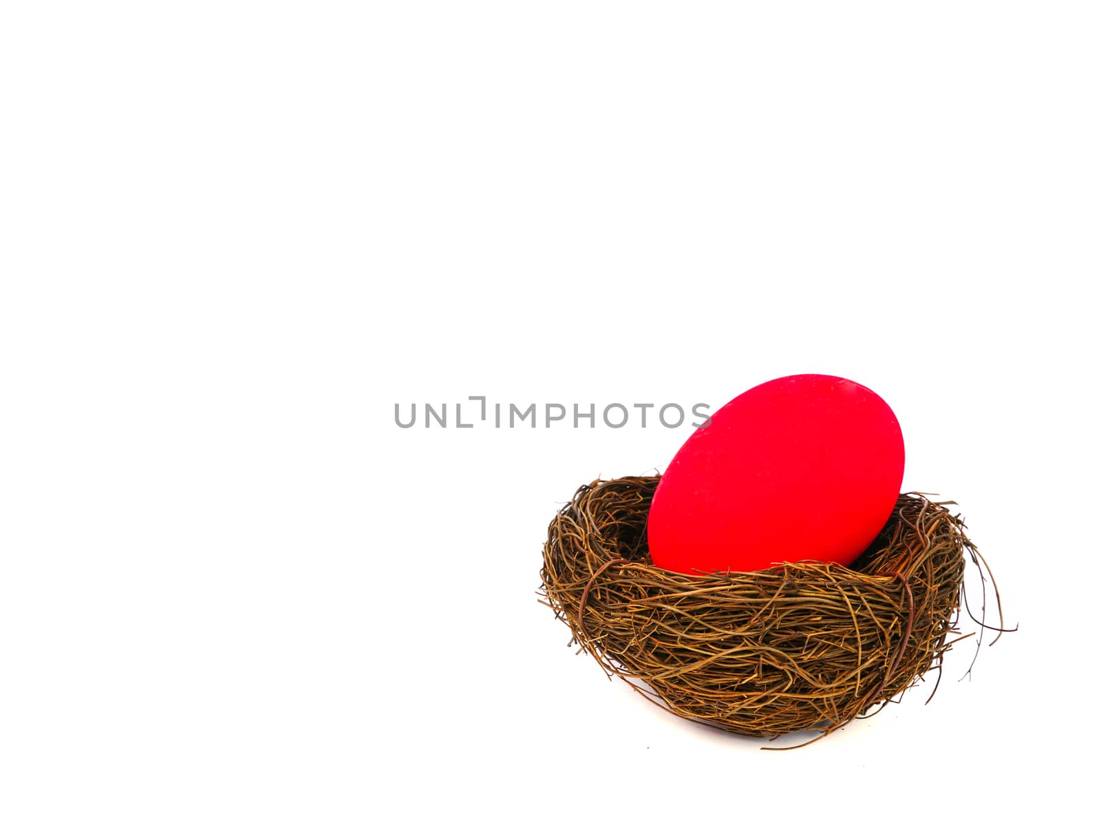 red easter egg in a bird nest, isolated on white backgound