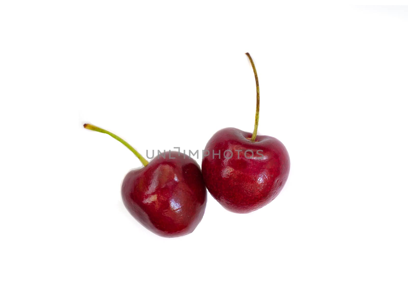 two shiny red cherries isolated on white background