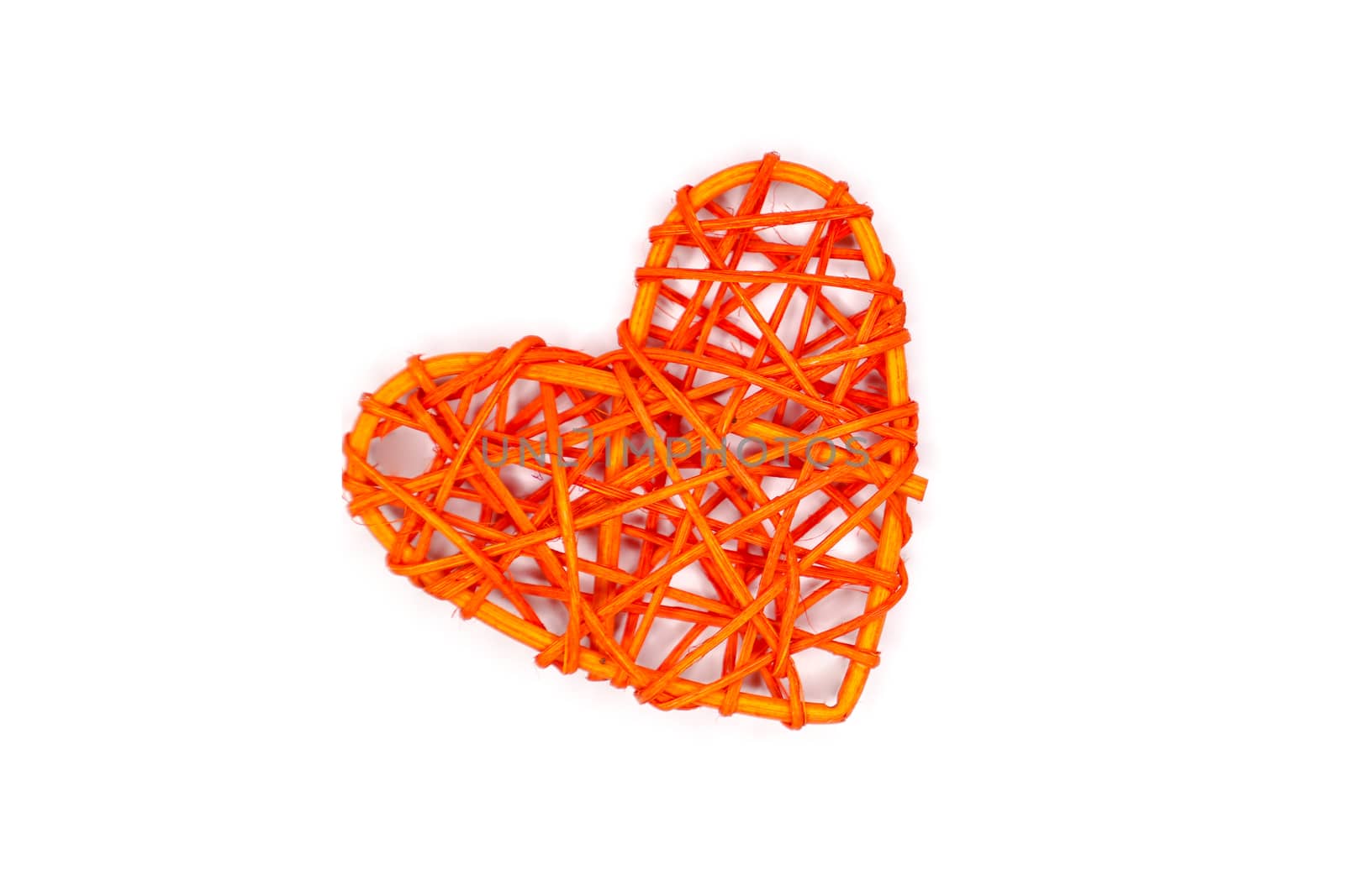 handmade orange rattan heart, isolated on white background