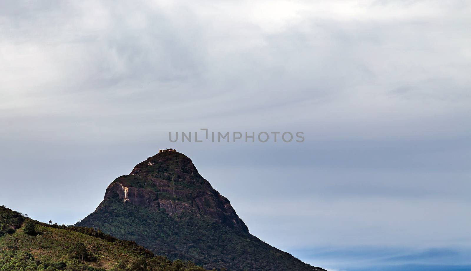 Sunrise over Adam's peak, Sri Lanka, mountain in the fog view from the jungle. Mountain landscape.