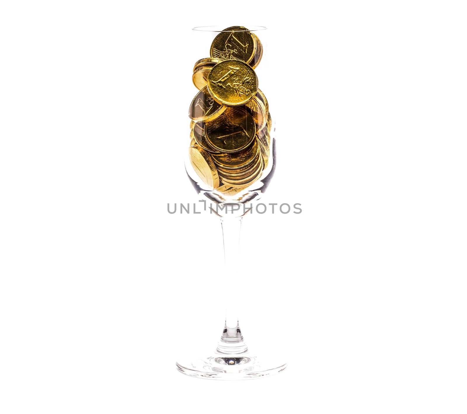 a heap of gold coins in a tall glass, isolated on white background