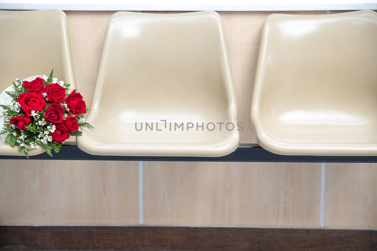 bright and beautiful blooming large roses with small delicate white flowers bouquet on a row of model style chairs, love romance wedding minimalism concept