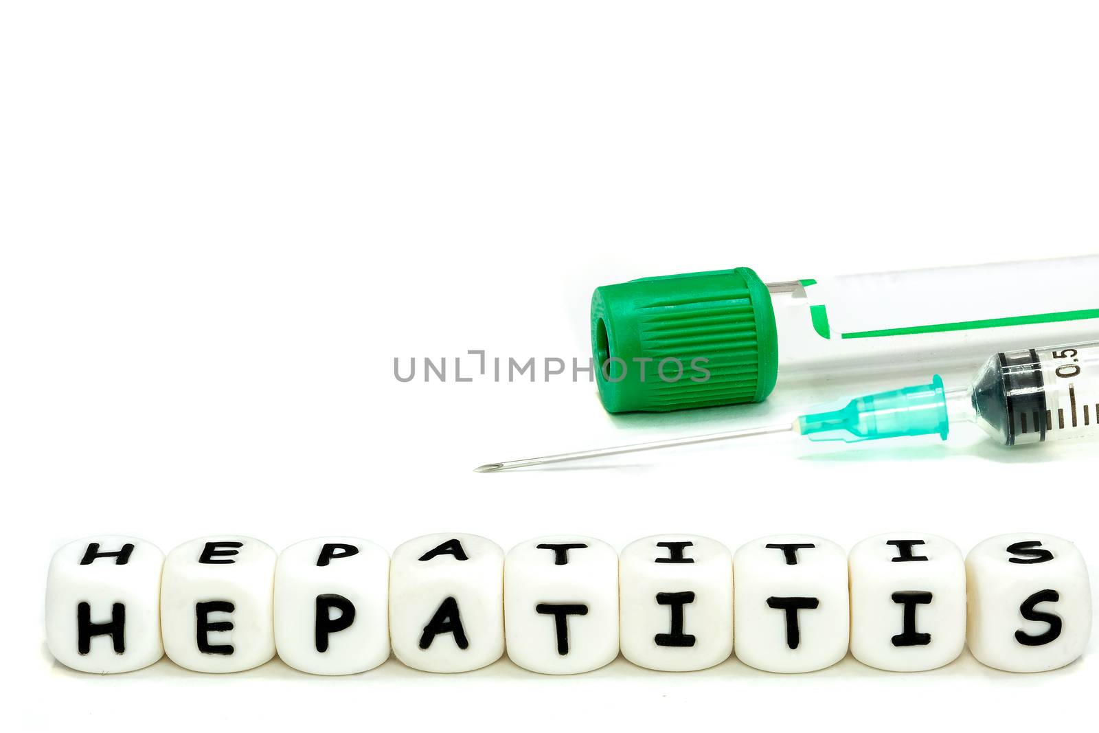A laboratory test tube and a syringe for blood sampling in the patient. The alphabet letters hepatitis emphasize the awareness of this serious condition. Macro image on white background.
