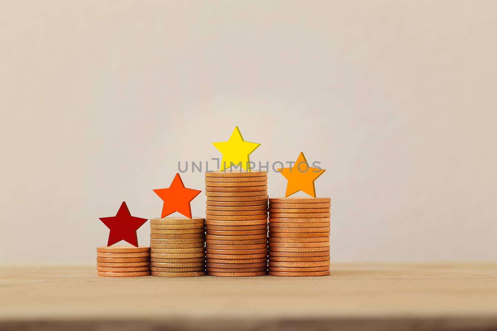 Arrange five star shape on rows of rising coins on table. The best excellent business services rating experience concept.