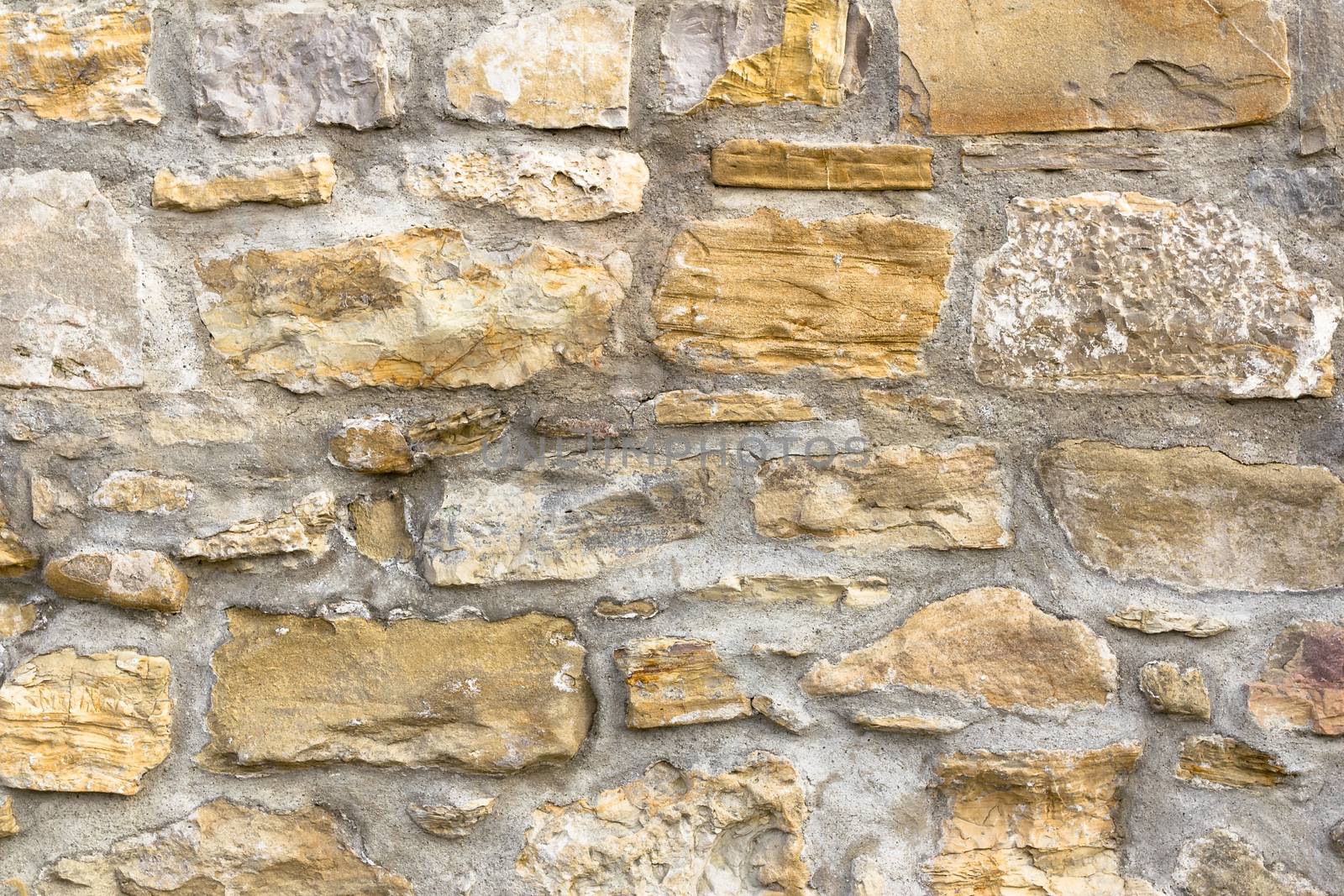 Details of a wall with big stones in irregular shapes.