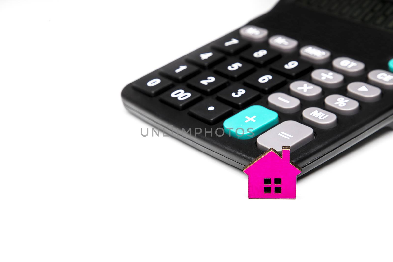 a small pink wooden house and a calculator, finance, mortage calculation concept