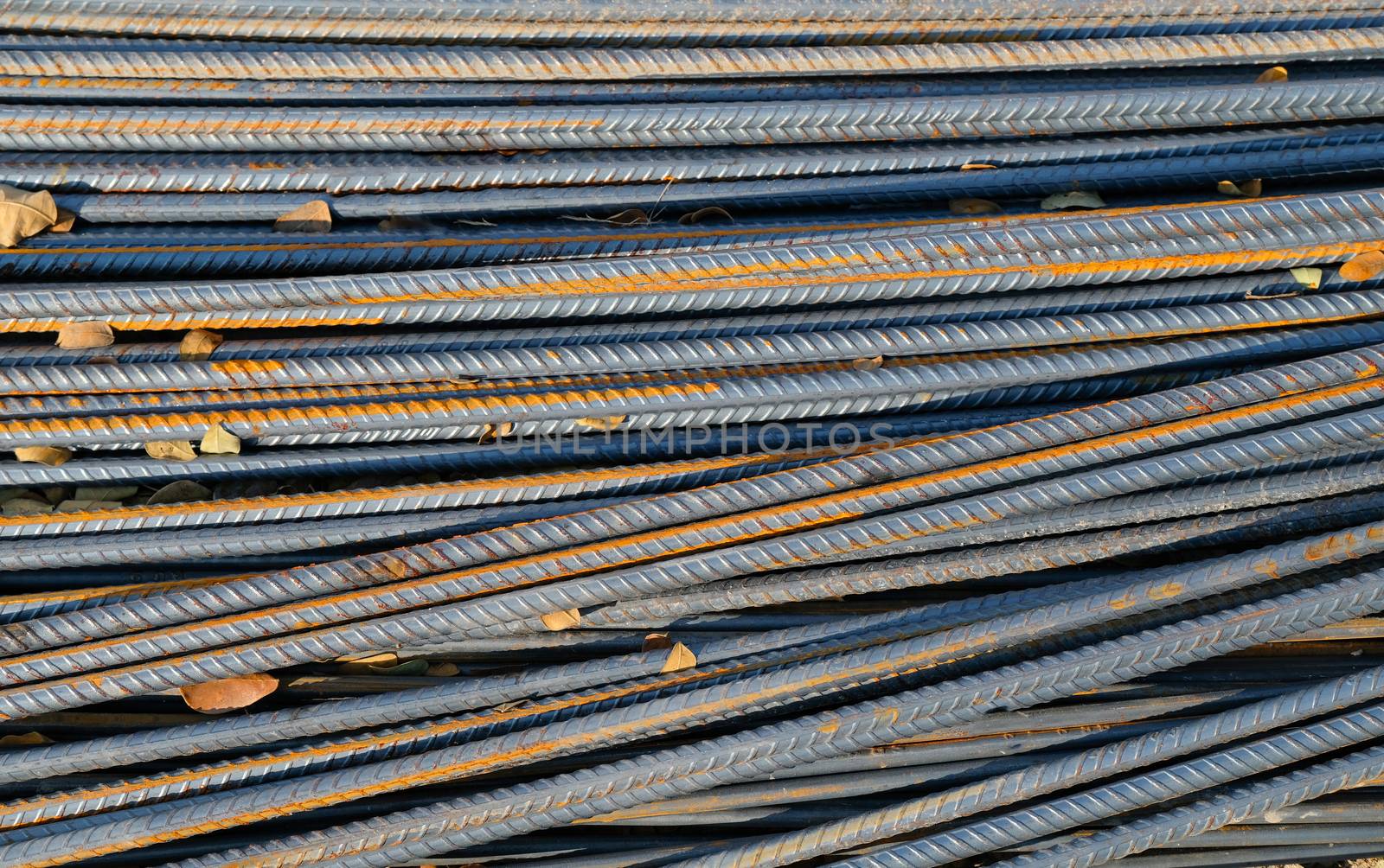 stack of old rusty iron rods for building construction