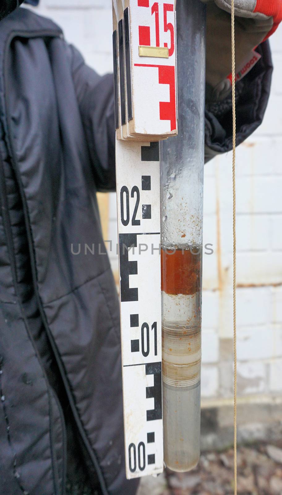 Floating oil in a sample from the groundwater on the site of a former tank farm 