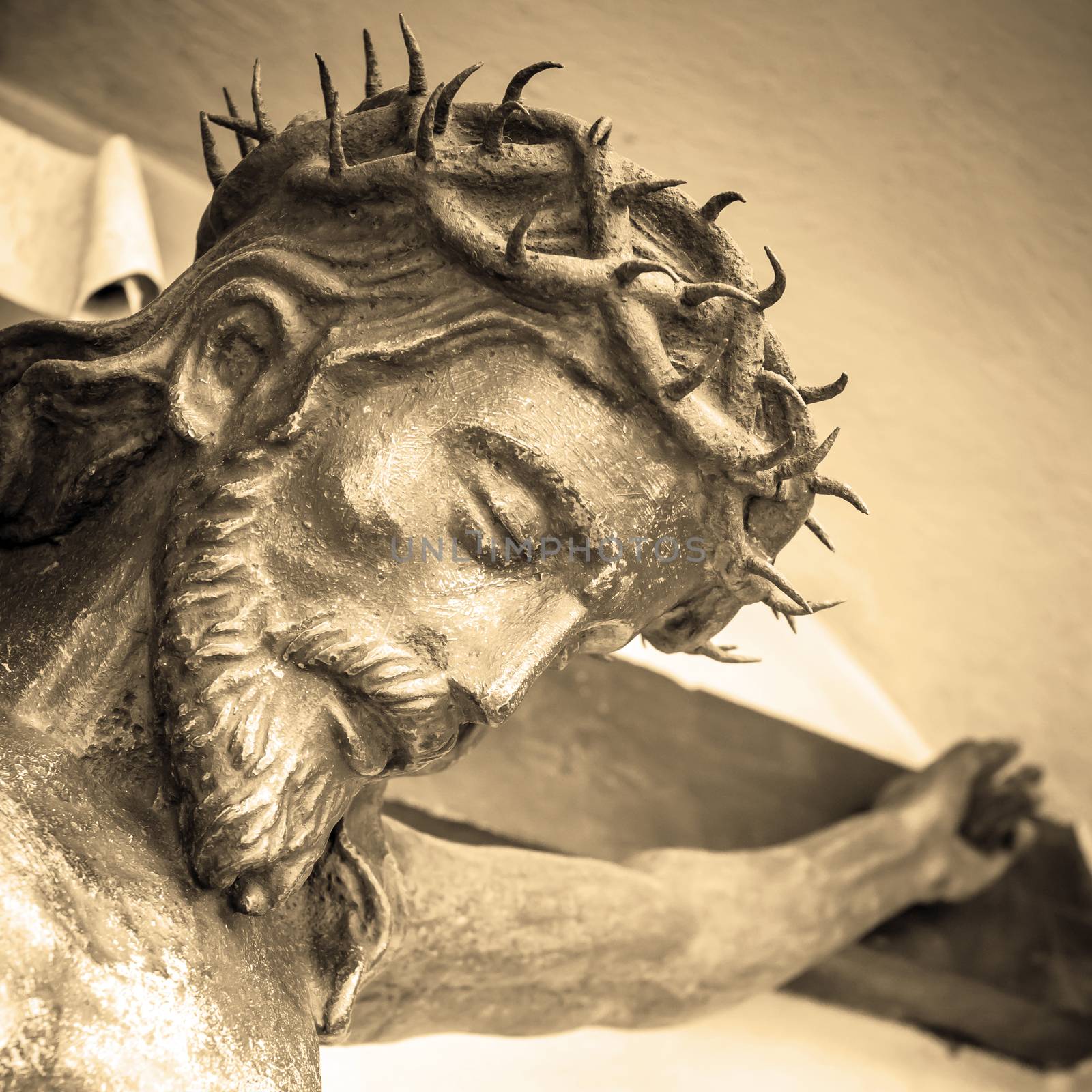 The suffering of Jesus Christ. Details of the bronze statue. Sepia tone.