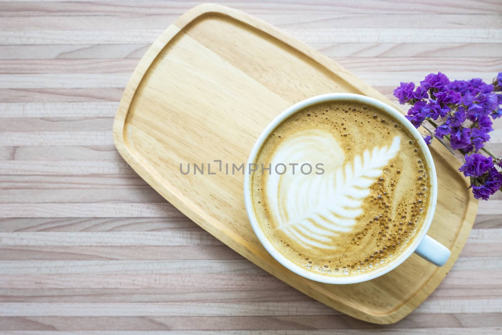 hot coffee with beautiful latte art in a white cup, top view, copy space