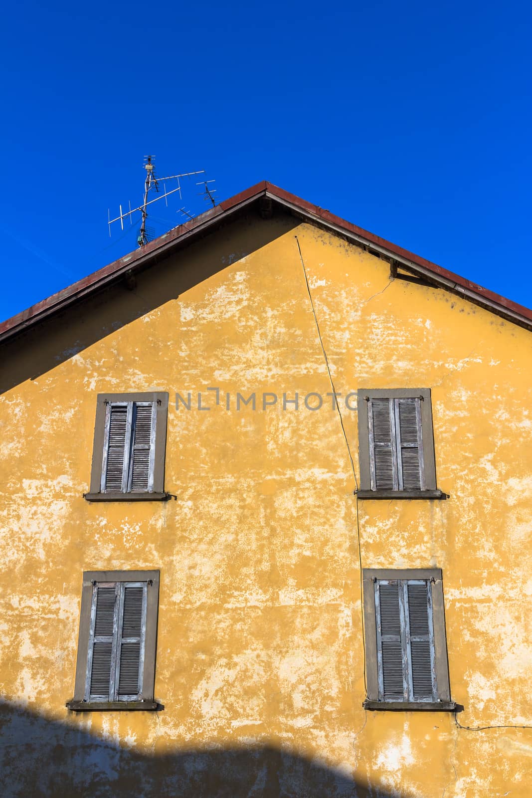 The facade of an old house with peeling plaster.