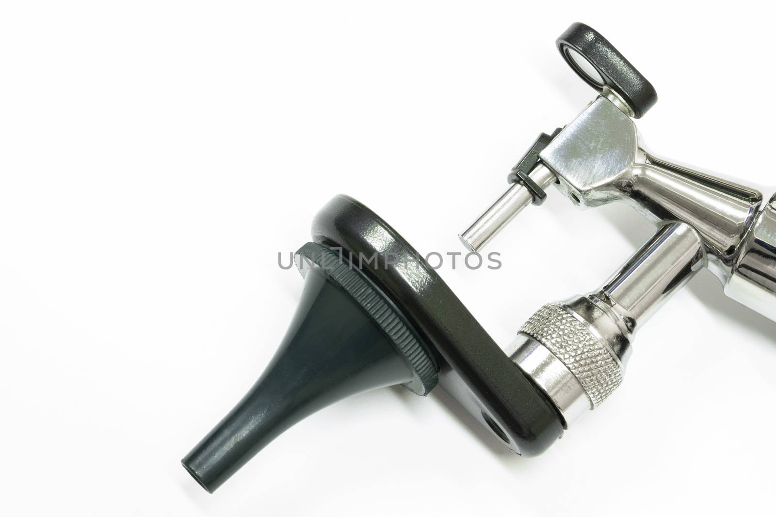 an otoscope, made of stainless steel, an important tool used by a otolaryngologist, or an ear doctor, to examime a patient's ear, isolated on white backgrown, closeup view