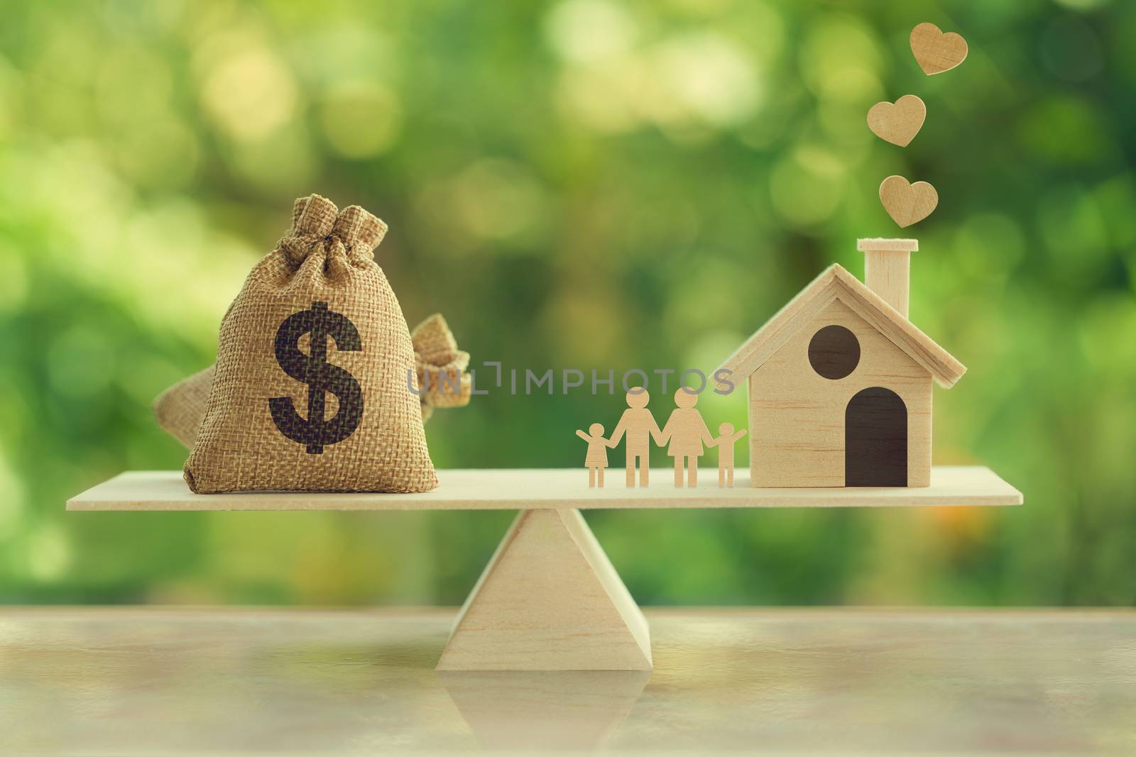 Property investment and house mortgage concept: Wooden home, Family member and US dollar hessian bags on wooden balance scale. depicts family financial management for a residence.