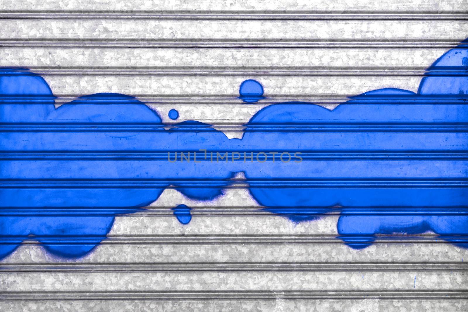 Blue bubbles painted with spray paint on a roller shutter.