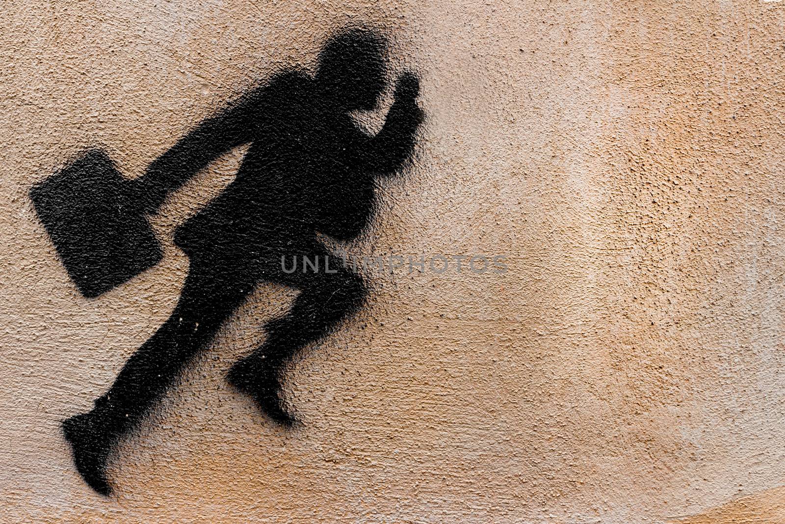 Graphical representation of a runner businessman on a plastered wall.