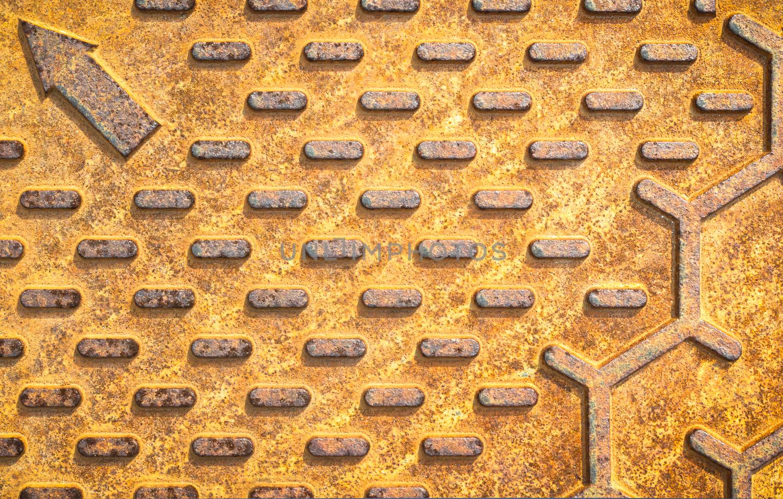 Steel rusty texture from Manhole cover. Orange metallic background. Detail of Manhole cover pattern.