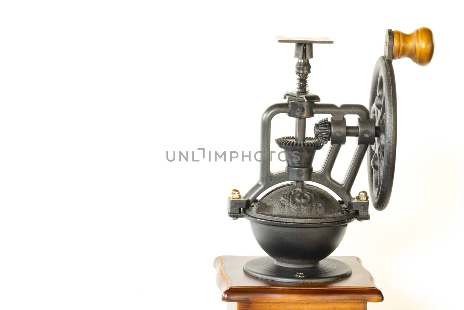 a vintage coffee grinder with intricate metal part, isolated on white background