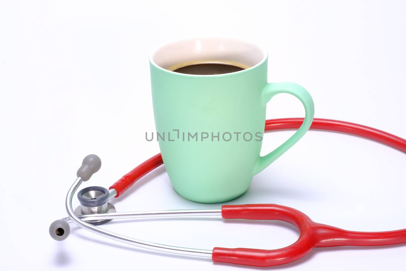 a light green coffee mug with hot coffee with milk and a red pediatric stethoscope placing around it, isolated on white background