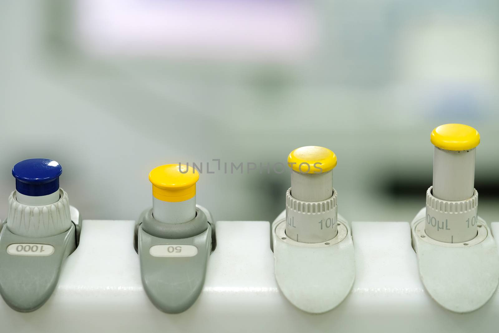 a set of measuring pipetted on a rack in the laboratory, blurred background