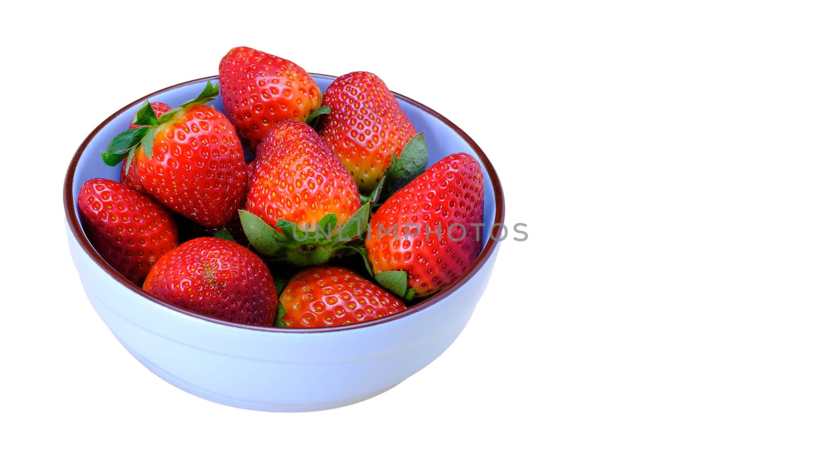 a bunch of large strawberries on a blue ceramic bowl, isolated on white background, copy space