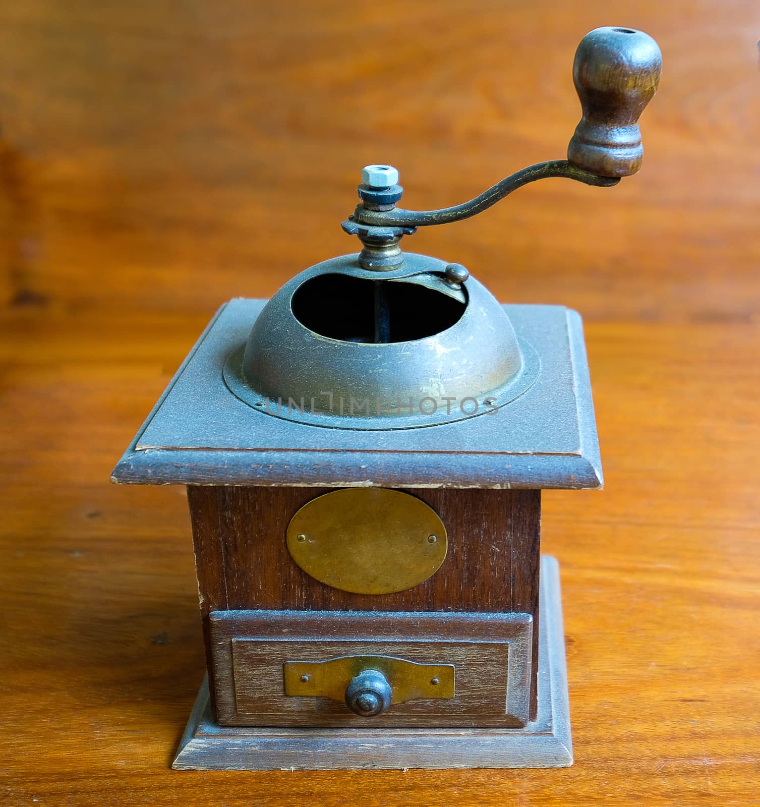 a vintage coffee grinder isolated on wooden background