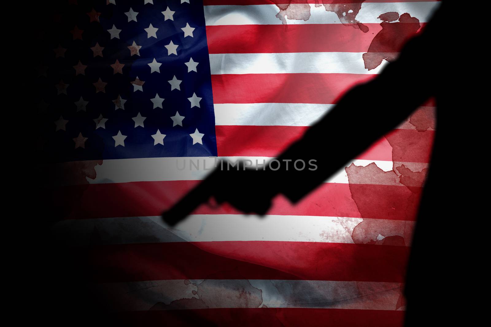 handgun in gunman hand with blood stain on American flag. reform gun control in America concept by asiandelight