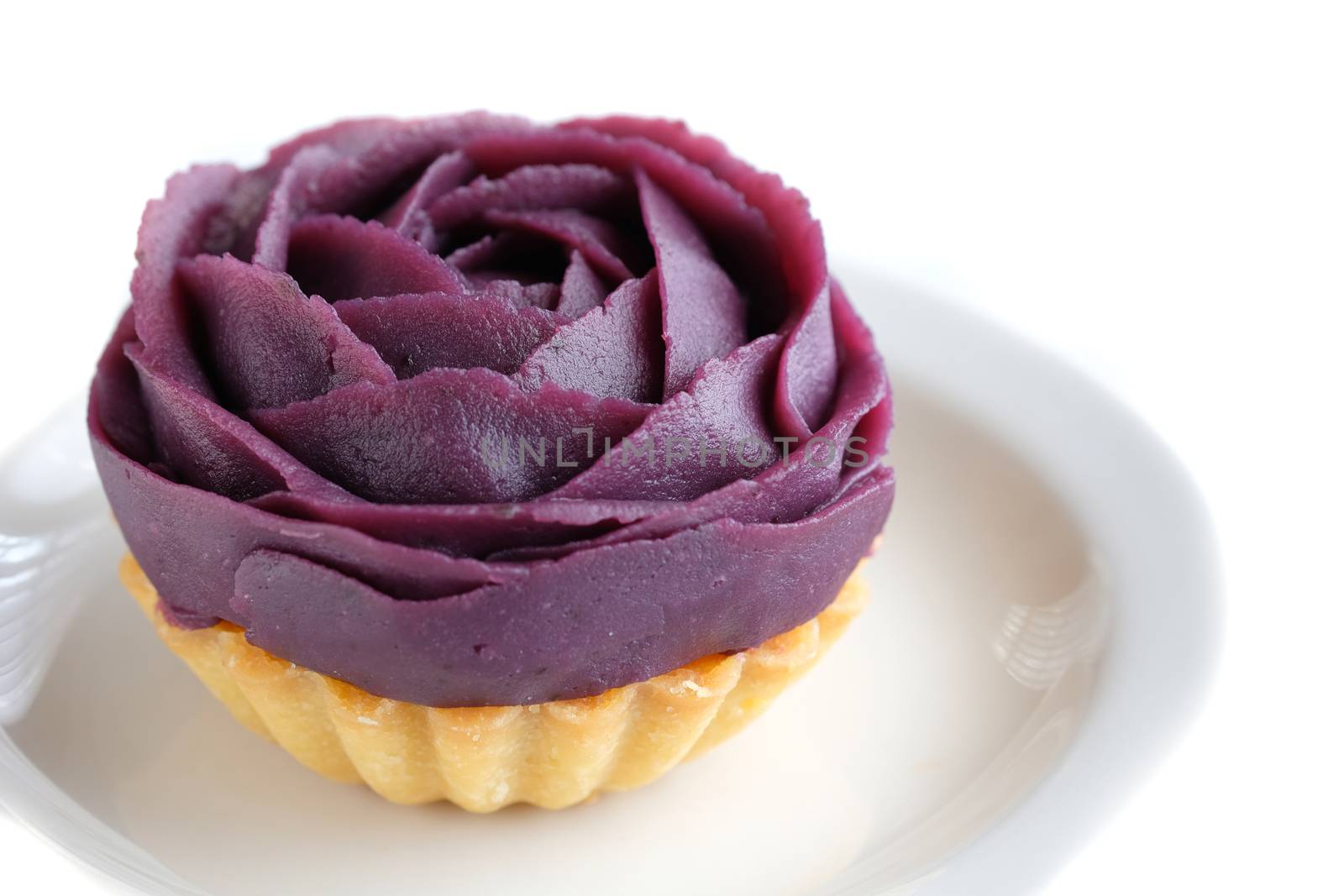 a flower shaped purple Japanese sweet potato tart, isolated on white background