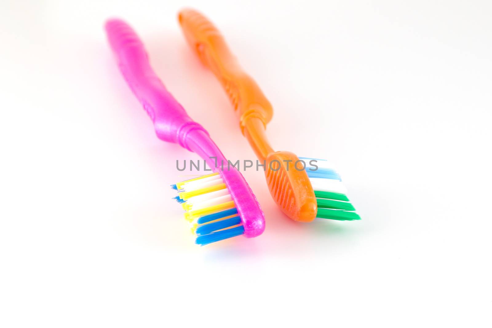 Two tooth-brushes over white