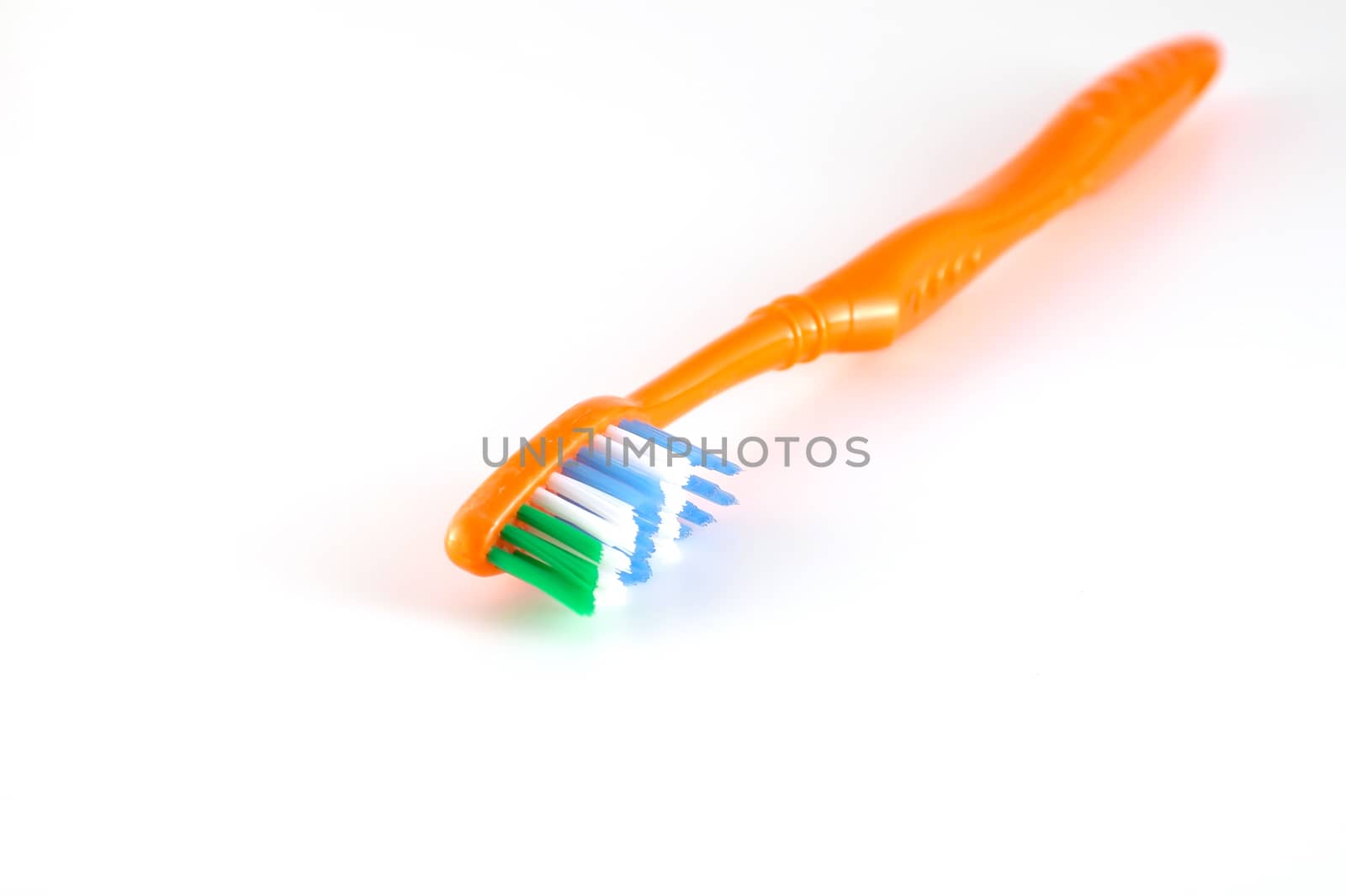 Orange toothbrush over neutral
