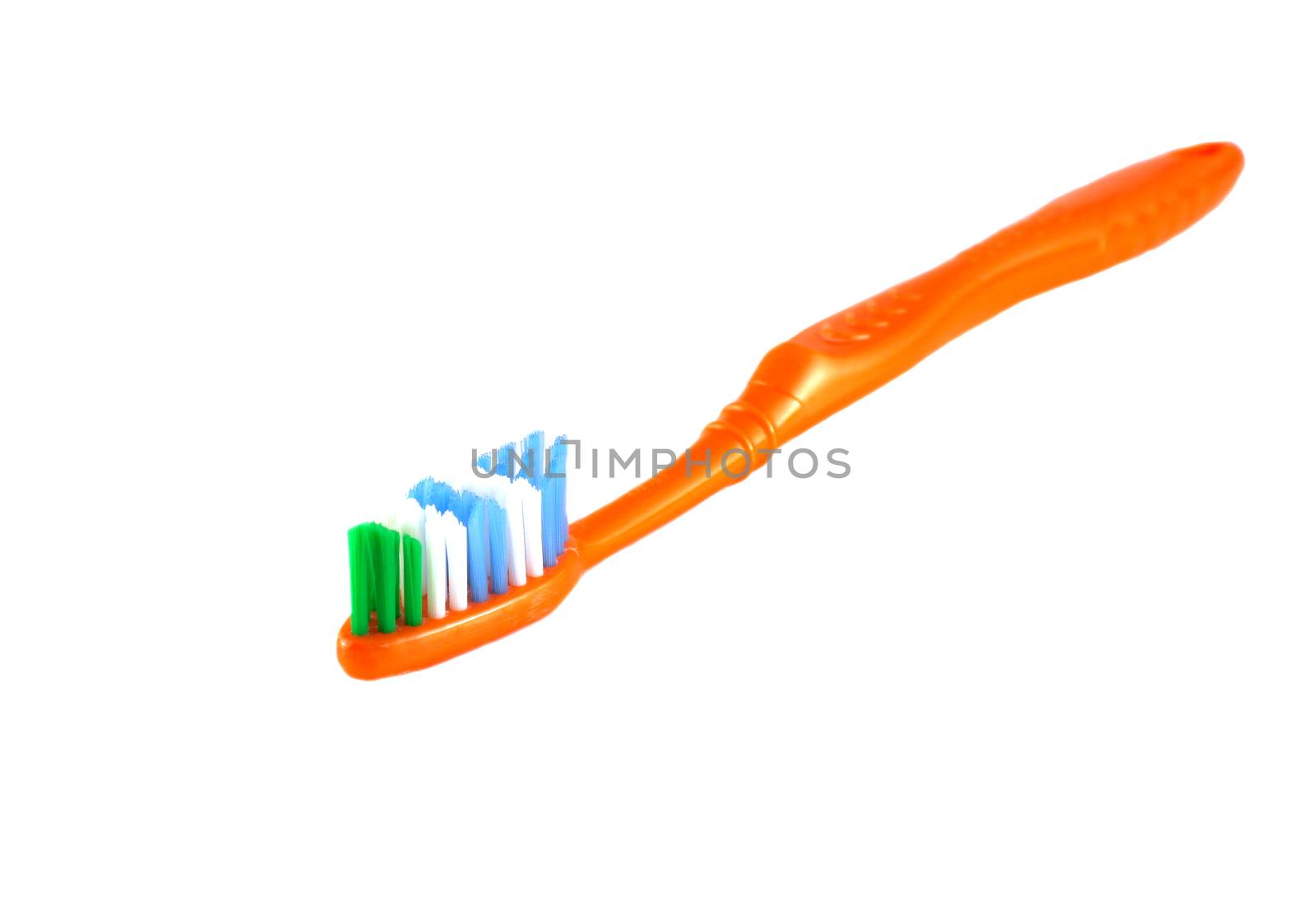 Orange toothbrush over white by sergpet