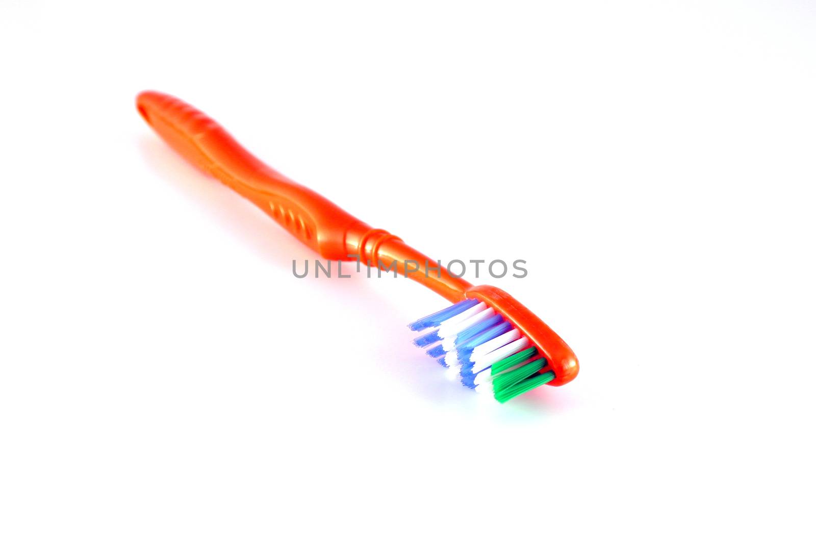 Orange toothbrush over white
