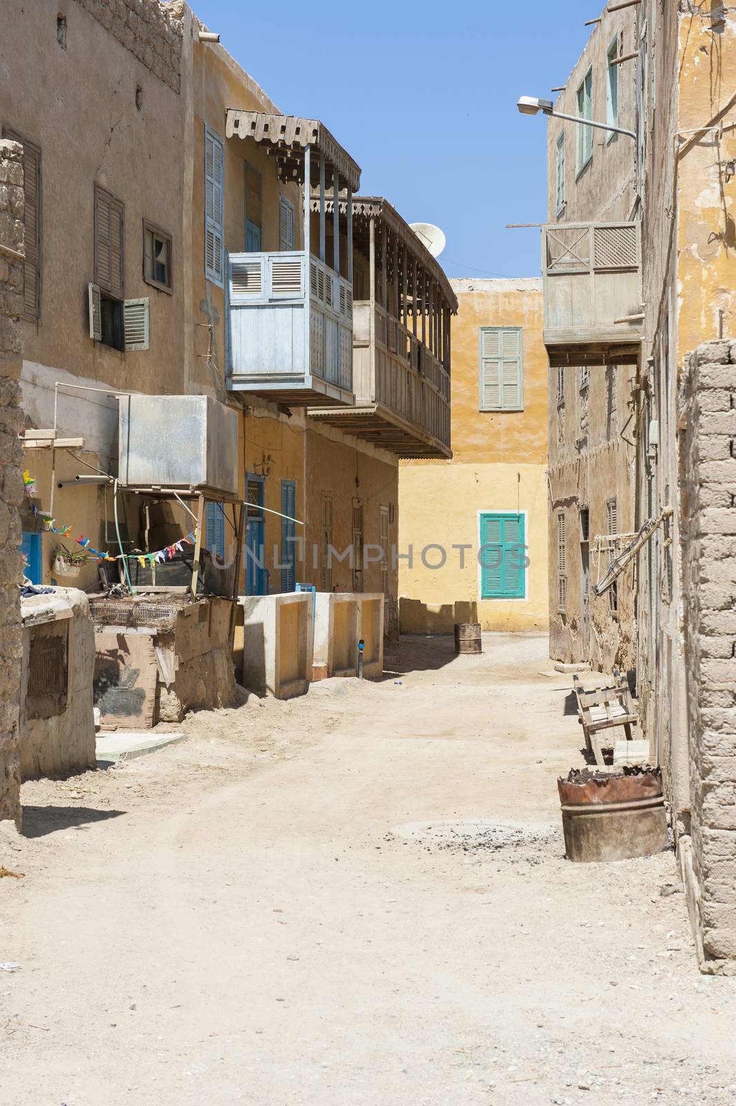 Old derelict traditional buildings with wooden balcony in an african egyptian town