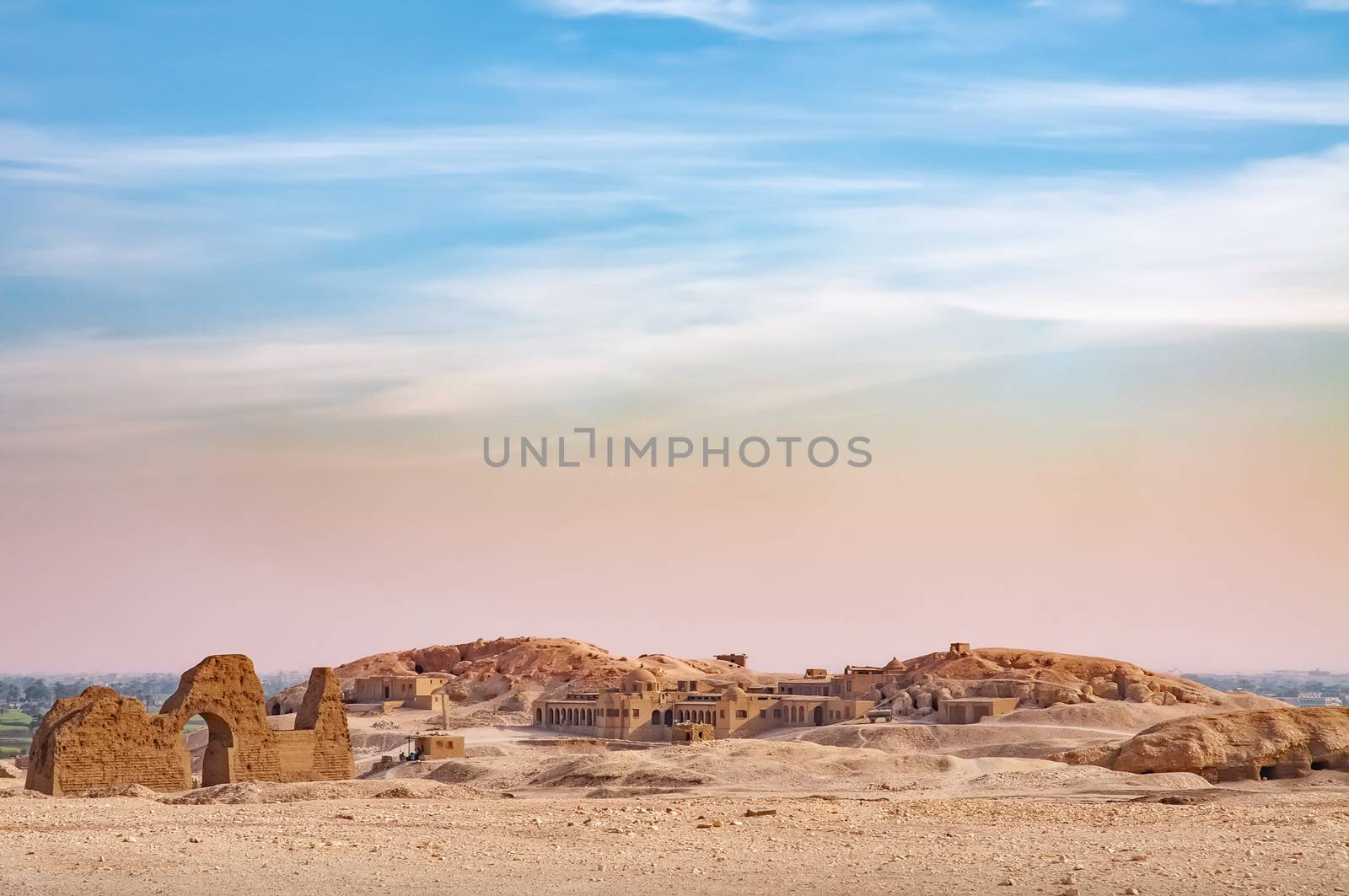 View of  the Valley of the Kings in Egypt, with a blue and pink sky over the desert