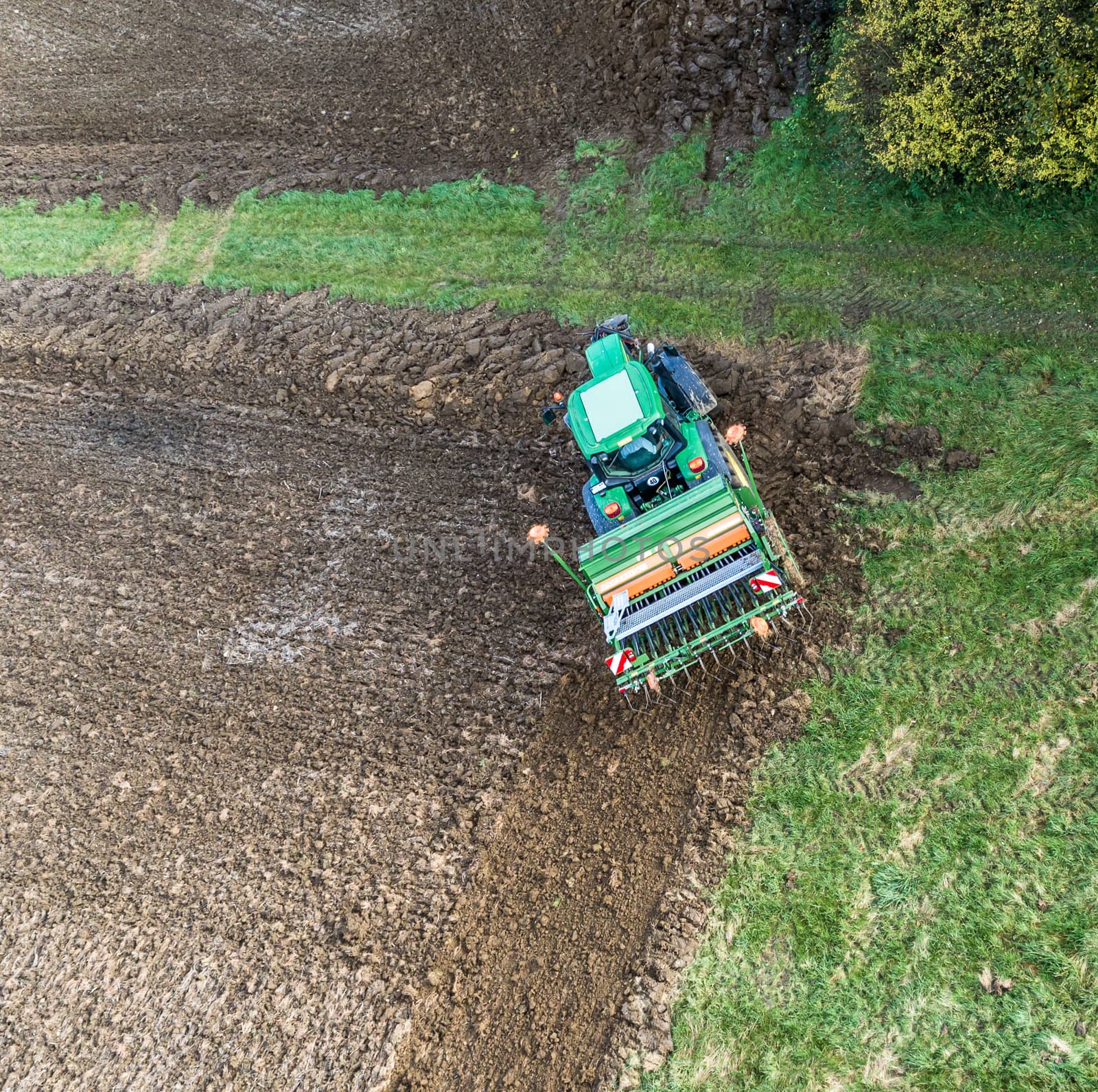 Aerial photograph of a tractor working in the field, turning the tractor at the corner of the field.