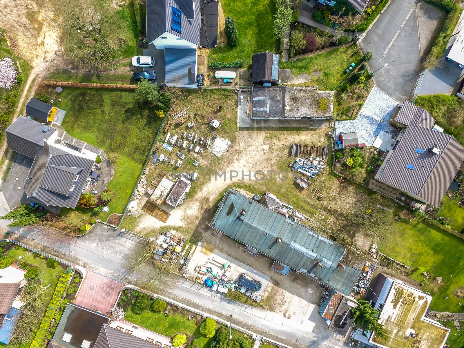 Storage site for a construction company in a residential area, aerial photograph with the drone