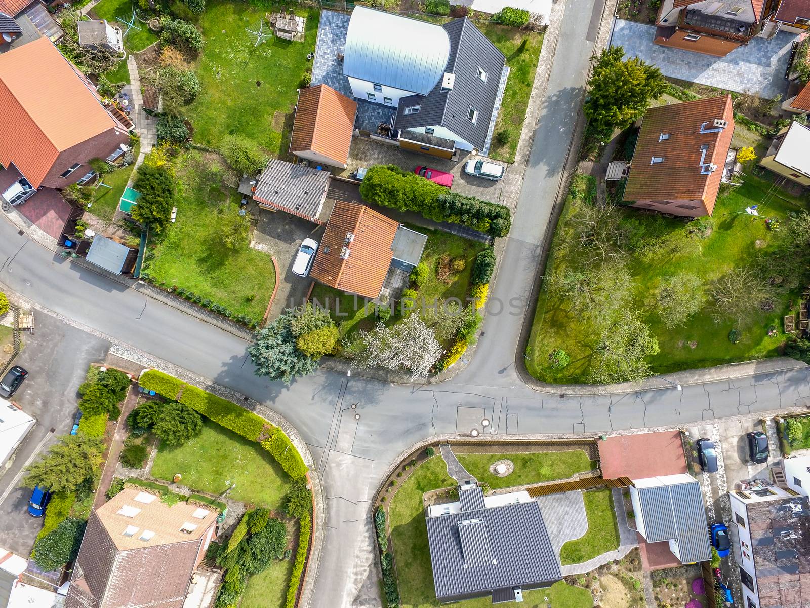 Aerial photo with the drone, a new build-up plot with single houses and gardens, narrow neighborhood