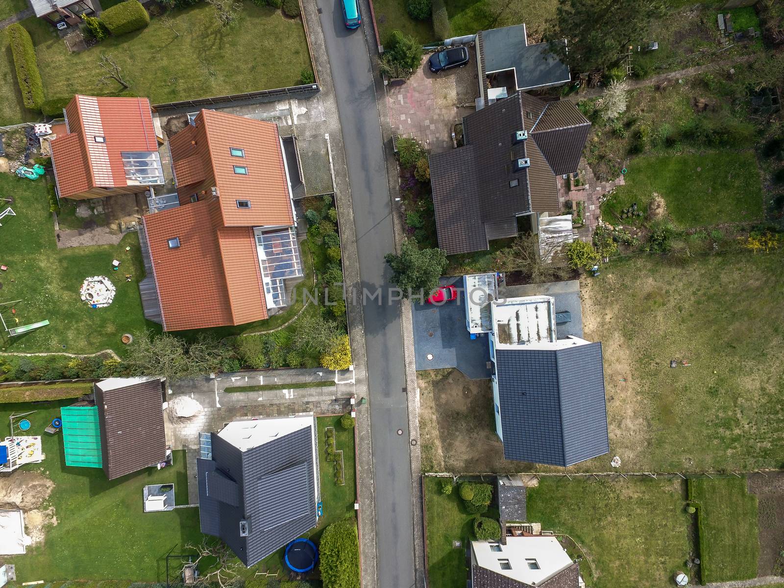 Aerial photo with the drone, a new build-up plot with single houses and gardens, narrow neighborhood