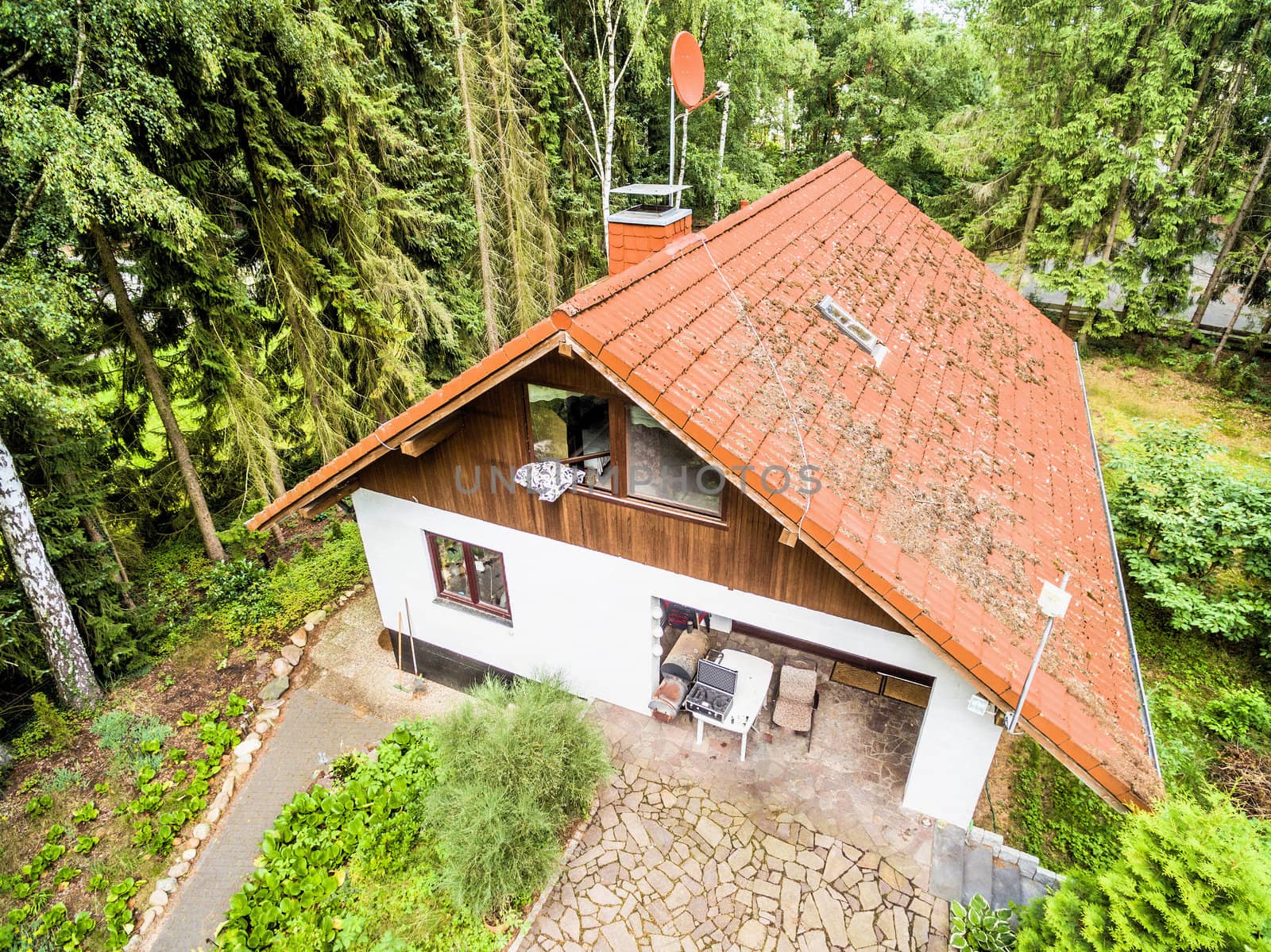 House for a family in the forest, aerial view with drone