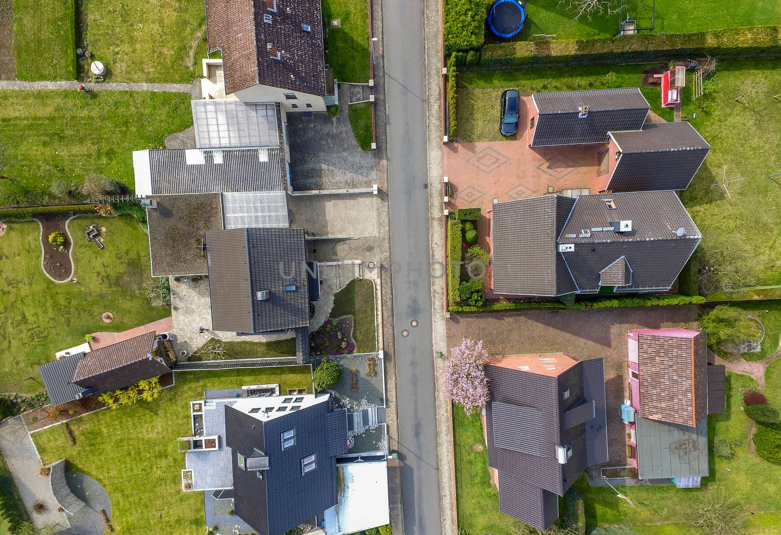 Aerial photo with the drone, a new build-up plot with single houses and gardens, narrow neighborhood