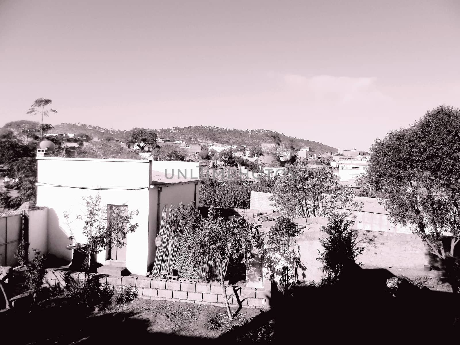 Eritrea, Africa - 08/10/2019: Travelling around the vilages near Asmara and Massawa. An amazing caption of the trees, mountains and some old typical houses with very hot climate in Eritrea.