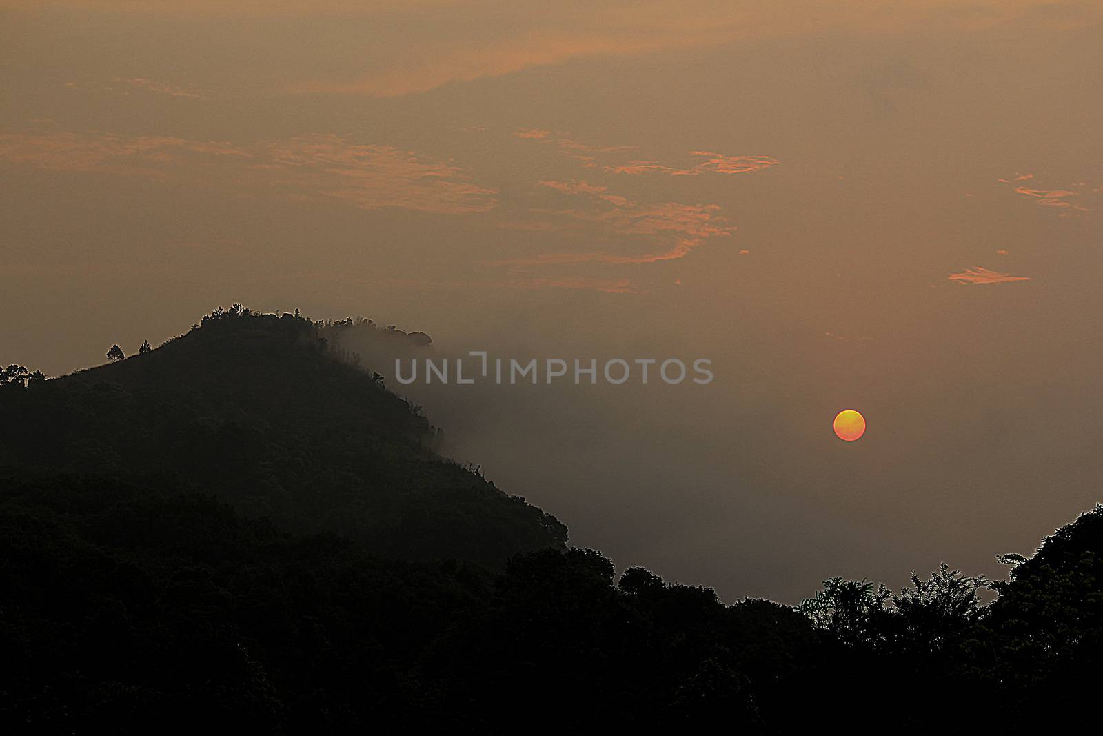 Mountain landscape and sunset in the fog by Puripatt