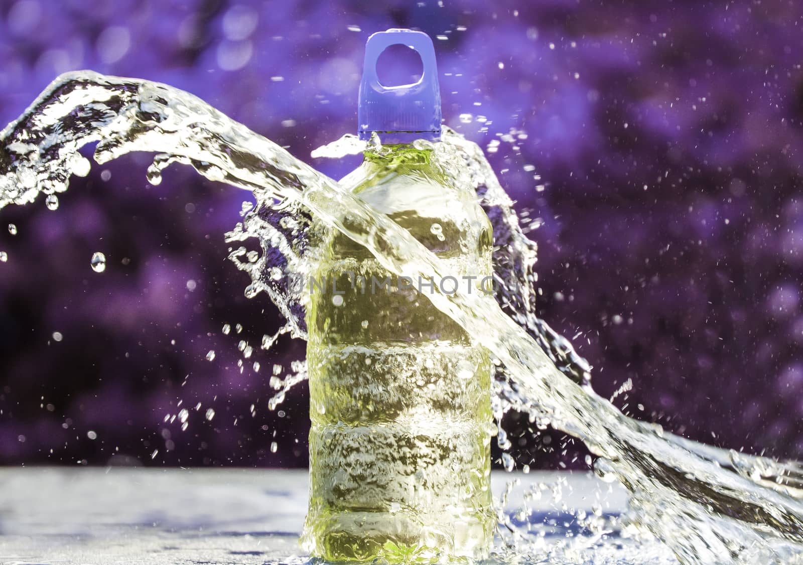 Fresh water splashing around of pure water bottle with blurred background. Selective focus and space for text. by TEERASAK