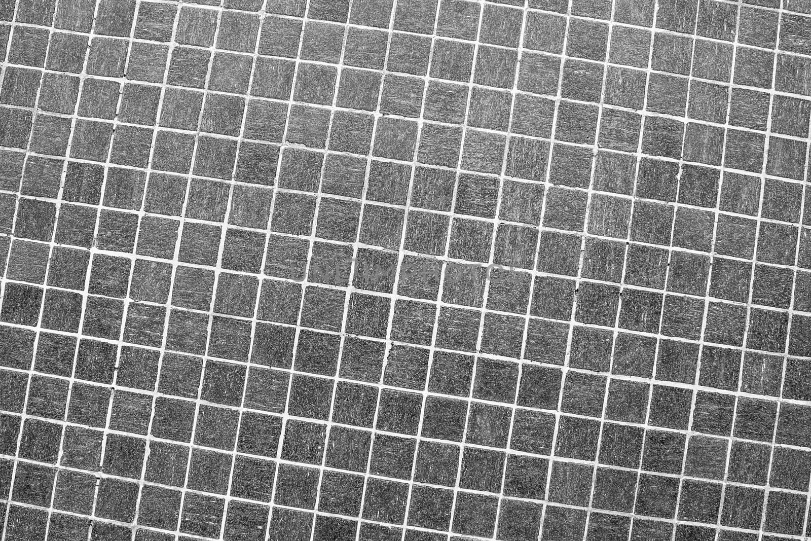 Small grey square mosaic tiles abstract background and texture.
