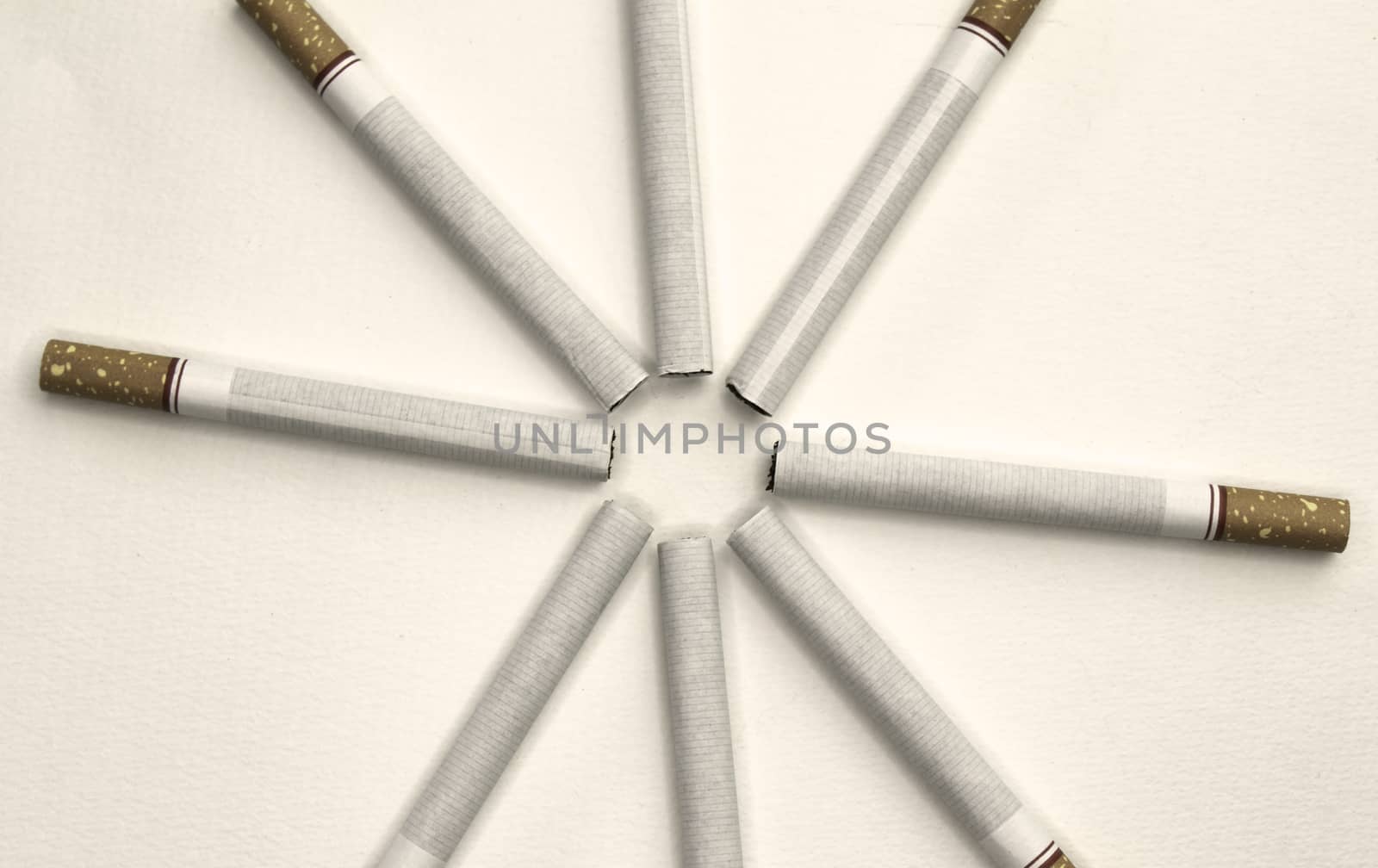 World No Tobacco Day; Sort cigarettes in a circle on grey background. by TEERASAK