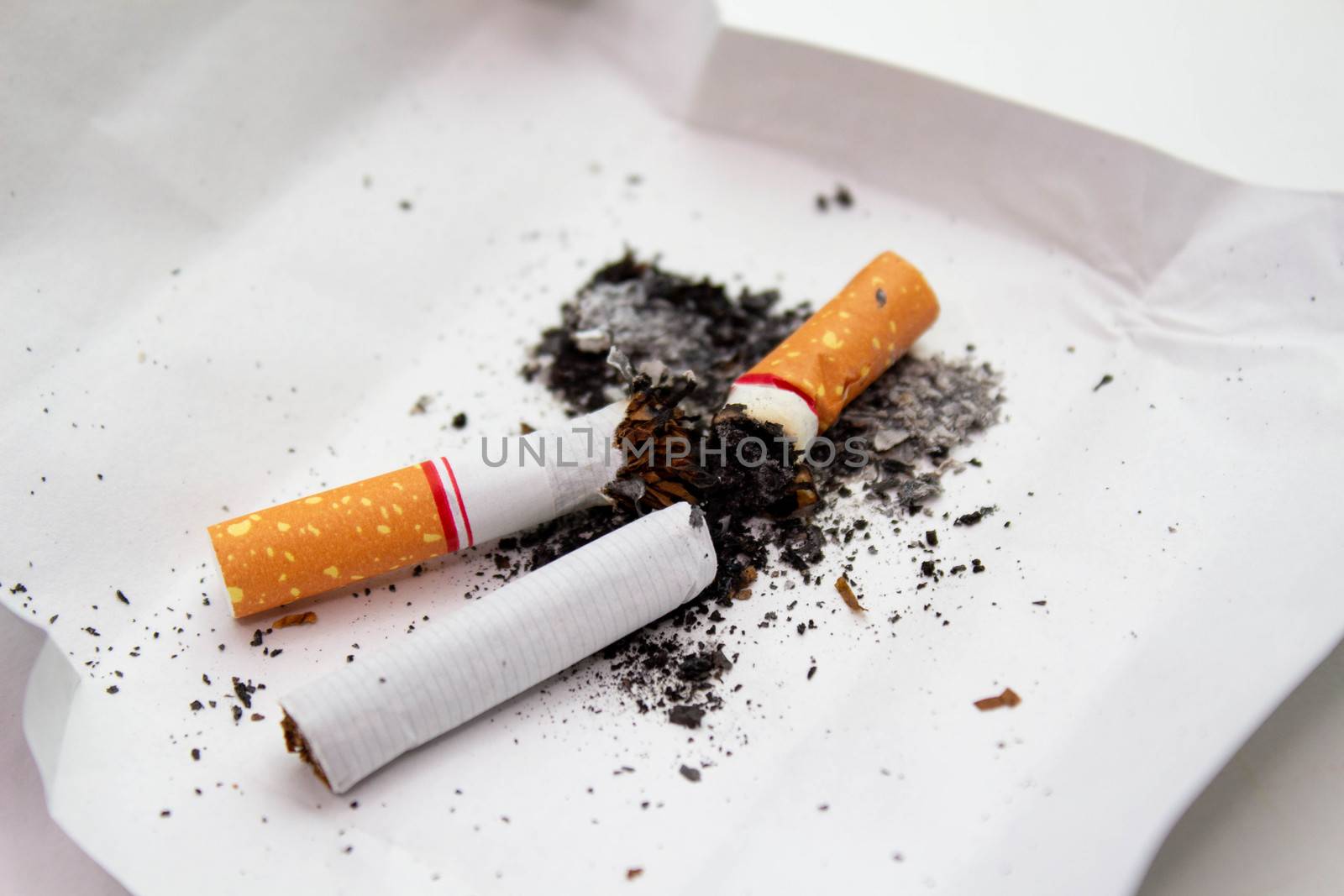 World No Tobacco Day; Cigarette with black ashes isolated on white background and space for text. by TEERASAK