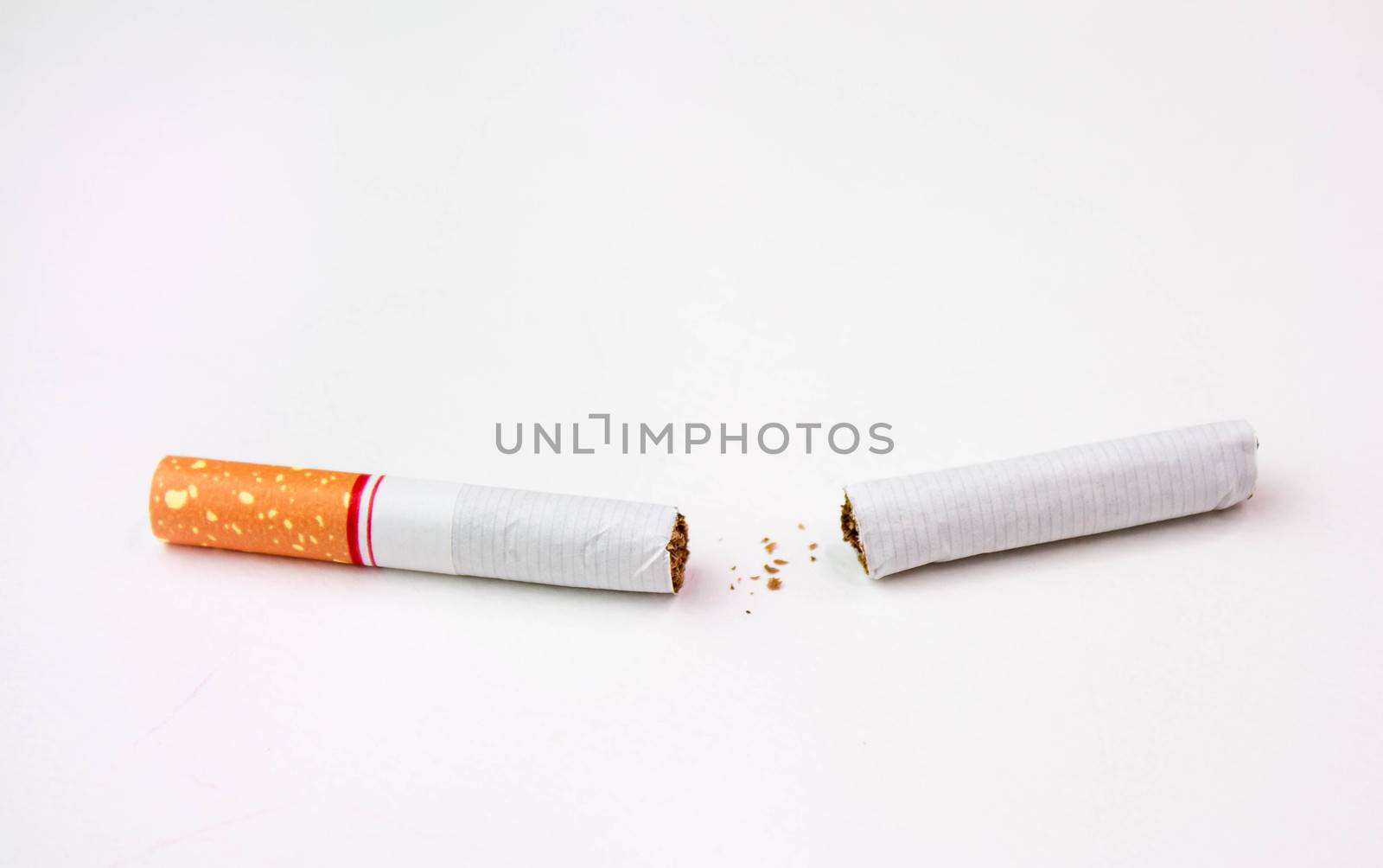 World No Tobacco Day; Broken cigarette isolated on white background. Cigarette destruction concept by TEERASAK