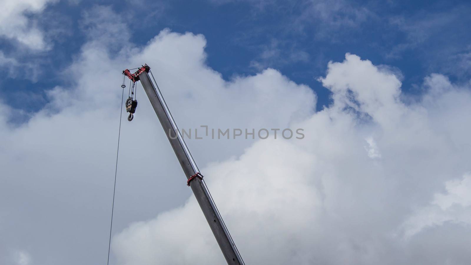 Crane hook on a blue sky background. by TEERASAK