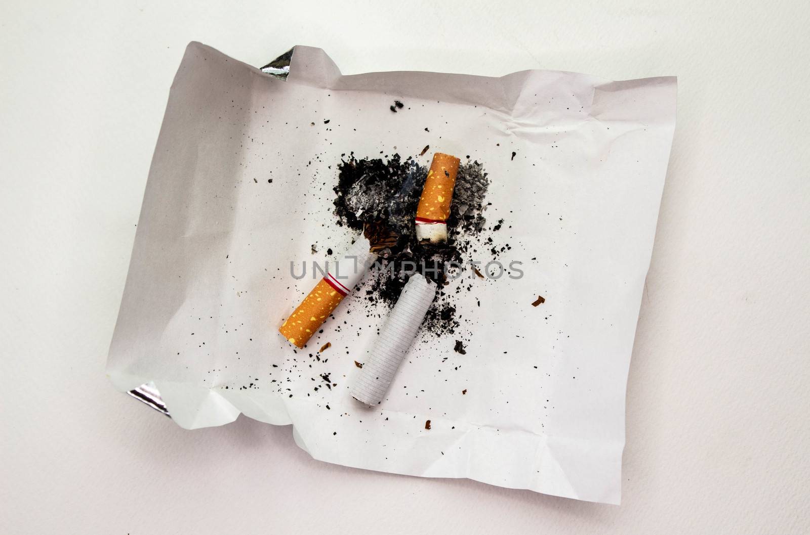 World No Tobacco Day; Cigarette with black ashes isolated on white background and space for text.